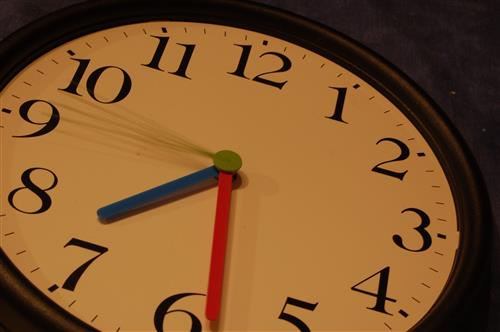 Clock with blue and red hands reading 7:30 